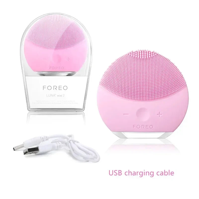 Pink silicone facial cleansing brush for sensitive skin with USB charging cable by Sheluxe