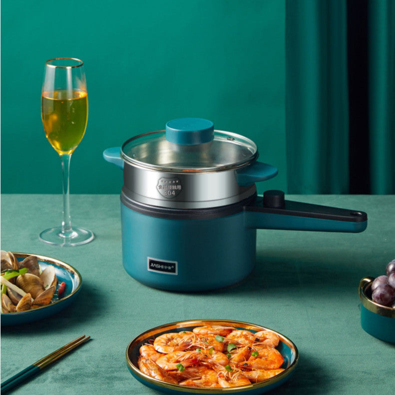Nutritea portable electric pot for dorm in teal with glass lid surrounded by seafood dishes and a glass of drink